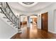 Elegant foyer featuring a curved staircase, hardwood floors, and views into adjoining rooms at 4600 E 3Rd Ave, Denver, CO 80220