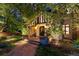 Charming front entrance featuring a brick walkway, stone archway, and lush landscaping at 4600 E 3Rd Ave, Denver, CO 80220