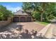 Three-car garage with a brick exterior and a brick paved driveway at 4600 E 3Rd Ave, Denver, CO 80220