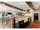 Open-concept kitchen with a center island, farmhouse sink, and views to dining area at 4600 E 3Rd Ave, Denver, CO 80220