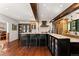 Modern kitchen with a large island, bar seating, and dark wood accents at 4600 E 3Rd Ave, Denver, CO 80220