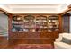 Elegant library featuring built-in bookshelves and hardwood floors at 4600 E 3Rd Ave, Denver, CO 80220