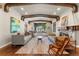 Inviting living room featuring exposed wood beams, a bay window, and a cozy fireplace at 4600 E 3Rd Ave, Denver, CO 80220