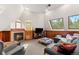 Cozy living room featuring a fireplace, wood paneling, and sloped windows at 4600 E 3Rd Ave, Denver, CO 80220