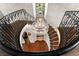 Grand staircase with iron railing, wood steps, and an elegant chandelier at 4600 E 3Rd Ave, Denver, CO 80220