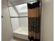 Bright bathroom featuring a bathtub with white subway tiles, a shower curtain, and a skylight at 12478 W Nevada Pl # 207, Lakewood, CO 80228
