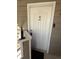 A white front door with security features provides a private entrance at 12478 W Nevada Pl # 207, Lakewood, CO 80228