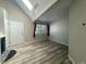 Bright living room featuring hardwood floors, high ceilings and natural light from the large window at 12478 W Nevada Pl # 207, Lakewood, CO 80228