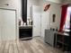 Living space with black fireplace, wood-look tile, and exterior door at 12478 W Nevada Pl # 207, Lakewood, CO 80228