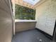 Enclosed private outdoor patio with brick wall and lush trees providing shade at 12478 W Nevada Pl # 207, Lakewood, CO 80228