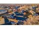 Aerial view of homes and community park with city skyline in distance at 2269 Coronado Pkwy # C, Denver, CO 80229