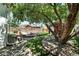 Backyard featuring a stone patio, mature tree, and lush greenery at 2660 Julian St, Denver, CO 80211