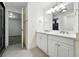 Bright bathroom with dual vanity, white cabinets, and modern fixtures at 2660 Julian St, Denver, CO 80211