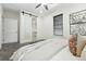A modern bedroom with walk-in closet, neutral walls, and ceiling fan at 2660 Julian St, Denver, CO 80211
