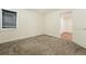 Inviting carpeted bedroom with window and view into a bright hallway at 2660 Julian St, Denver, CO 80211