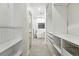A walk-in closet and bathroom combination with custom shelving and lots of storage at 2660 Julian St, Denver, CO 80211