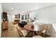 Open-concept dining area with modern chairs, wood table, and seamless flow to the living spaces at 2660 Julian St, Denver, CO 80211