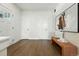 Bright entryway with hardwood floors, modern bench, and white doors leading to other rooms at 2660 Julian St, Denver, CO 80211