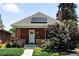 Charming brick home with solar panels, well-maintained landscaping, and a welcoming front entrance at 2660 Julian St, Denver, CO 80211