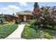 Charming brick home featuring a welcoming front porch and beautiful landscaping at 2660 Julian St, Denver, CO 80211