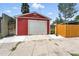 Red garage with white door and concrete driveway, enhancing the property's functionality at 2660 Julian St, Denver, CO 80211