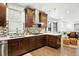 Beautiful, open kitchen featuring stainless appliances, white counters, dark wood cabinets, and modern backsplash at 2660 Julian St, Denver, CO 80211