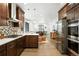 Beautiful, open kitchen featuring stainless appliances, white counters, dark wood cabinets, and modern backsplash at 2660 Julian St, Denver, CO 80211