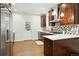 A charming kitchen with white quartz counters, stainless appliances, and wood-look tile floors at 2660 Julian St, Denver, CO 80211
