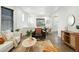 Bright living area featuring stylish decor, open layout, and seamless transition to the dining room at 2660 Julian St, Denver, CO 80211