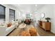 Stylish living room with open layout, hardwood floors, and comfortable seating arrangement at 2660 Julian St, Denver, CO 80211