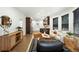Open-concept living room with hardwood floors, modern furniture, and seamless flow to the kitchen at 2660 Julian St, Denver, CO 80211