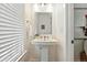 Cozy powder room featuring pedestal sink and stylish mirror at 2660 Julian St, Denver, CO 80211