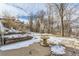 Backyard with patio, wooden steps and snowy ground at 4501 S Lipan Ct, Englewood, CO 80110