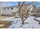 Backyard view of home, steps and snow covered ground at 4501 S Lipan Ct, Englewood, CO 80110