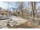 Snowy backyard with patio, wooden steps and trees at 4501 S Lipan Ct, Englewood, CO 80110