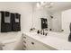 Modern bathroom with white vanity and marble shower at 4501 S Lipan Ct, Englewood, CO 80110