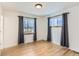 Bright bedroom with hardwood floors and two windows at 4501 S Lipan Ct, Englewood, CO 80110