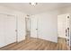 Well-lit bedroom with hardwood floors and access to bathroom at 4501 S Lipan Ct, Englewood, CO 80110