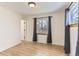 Spacious bedroom with hardwood floors and large window at 4501 S Lipan Ct, Englewood, CO 80110
