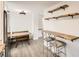 Kitchen breakfast nook with wooden table and floating shelves at 4501 S Lipan Ct, Englewood, CO 80110