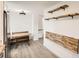 Eat-in kitchen with wooden table and floating shelves at 4501 S Lipan Ct, Englewood, CO 80110