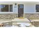 Inviting front door entry with stone accents and a new mat at 4501 S Lipan Ct, Englewood, CO 80110