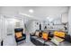 Open concept basement apartment featuring a living area and kitchenette at 7020 Avrum Dr, Denver, CO 80221