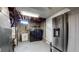 Clean basement laundry area with washer, dryer, and refrigerator at 7020 Avrum Dr, Denver, CO 80221