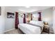 Bright bedroom with a king-size bed and two windows at 7020 Avrum Dr, Denver, CO 80221