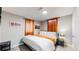 Cozy bedroom with a king-size bed and orange accents at 7020 Avrum Dr, Denver, CO 80221
