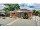 Brick ranch home with landscaped yard and walkway at 7020 Avrum Dr, Denver, CO 80221