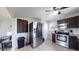 Updated kitchen with stainless steel appliances and gray countertop at 7020 Avrum Dr, Denver, CO 80221