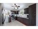 Modern kitchen with stainless steel appliances and dark cabinets at 7020 Avrum Dr, Denver, CO 80221