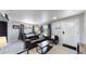 Living room with dark leather couch and dining area at 7020 Avrum Dr, Denver, CO 80221